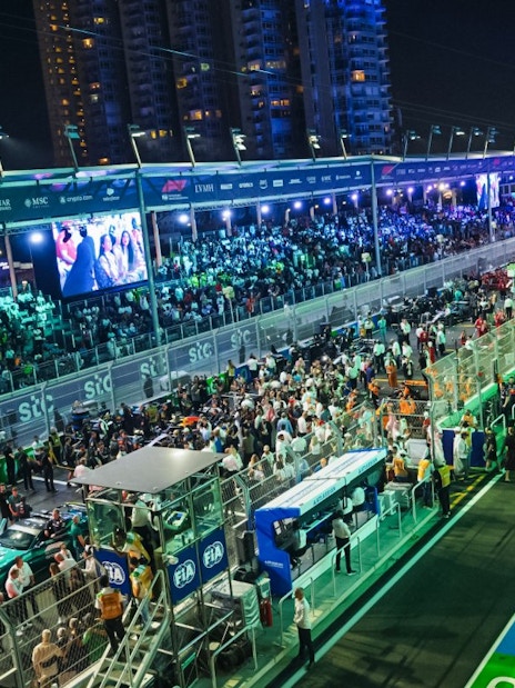 Crowds gather at the Formula 1 Jeddah Grand Prix 2026 starting grid under bright lights.